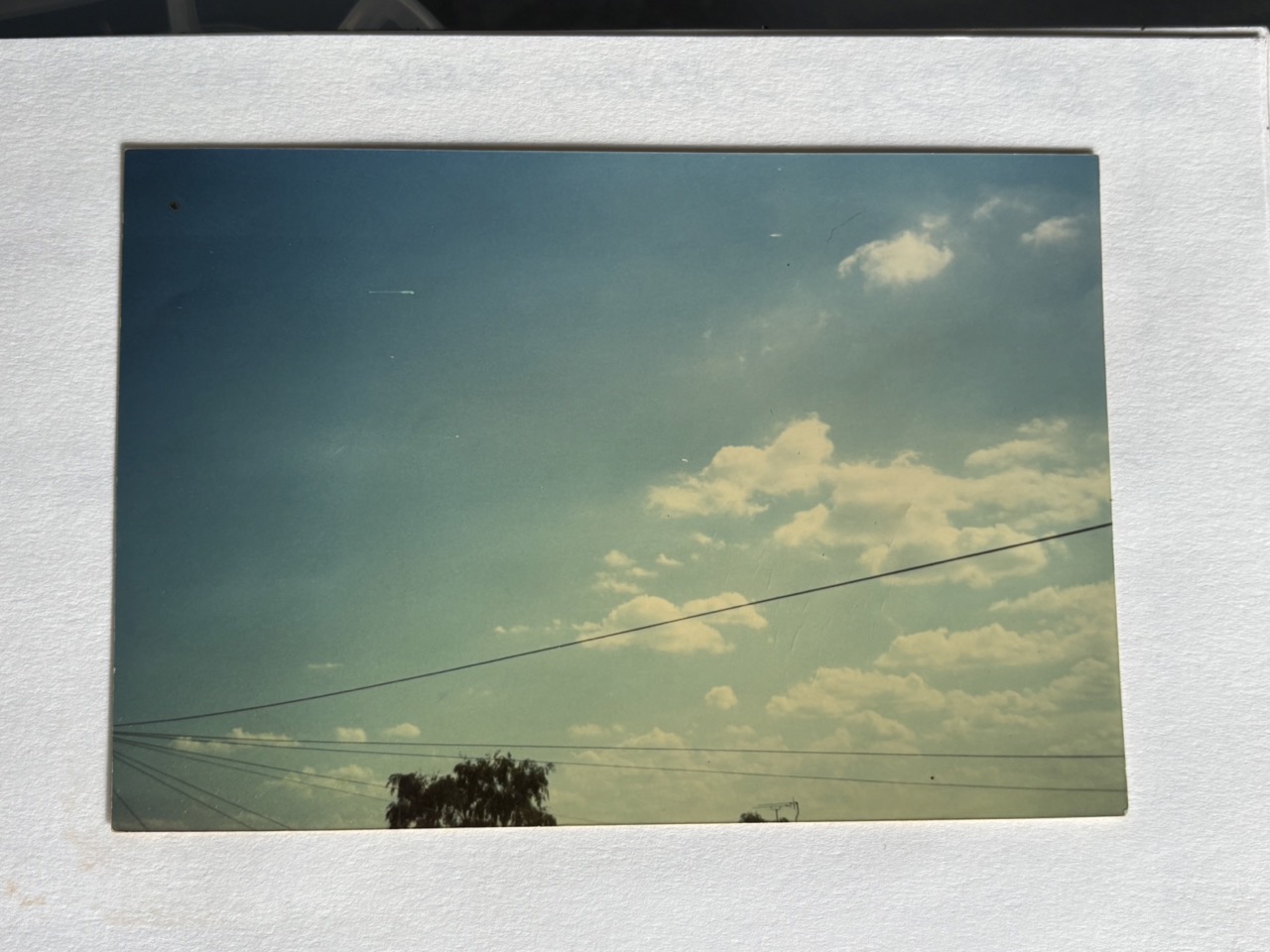 Photograph of a sky with telephone wires and clouds